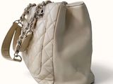 a white purse with a chain hanging from it