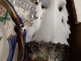 a white ghost mask sitting on top of a plate next to a plate