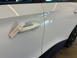 a white car with a sticker on the door handle
