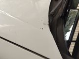a close up of a car door handle with a hole in it