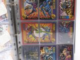 a binder with a bunch of comic cards in it