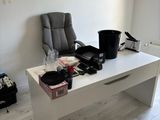 a desk with a chair and a chair in a room