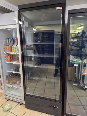 two refrigerators that are sitting in the middle of a store