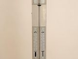 a tall white tower with a clock on top of it