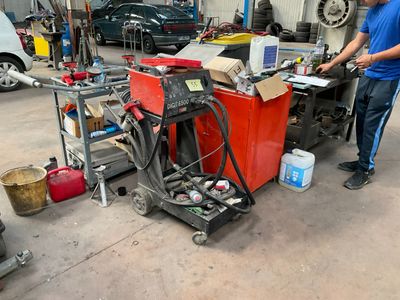 a man that is working on a machine in a garage