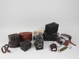 a lot of old cameras and other items on the table