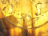 a gold plate with a picture of a man and a woman on it