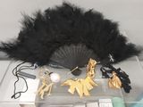 a black fan and some other items on a table