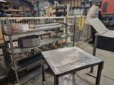 a metal table and a metal shelf in a warehouse