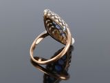 a gold and diamond ring with a blue stone center