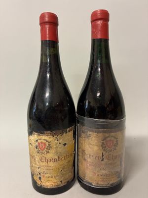 two bottles of wine sitting next to each other on a table