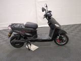 a scooter that is parked on a checkered floor