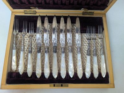 a wooden box with a set of silverware in it