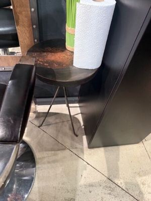 a chair and a table with a vase of flowers on it
