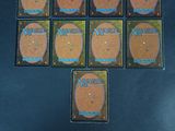 six decks of magic the gathering cards laid out on a table