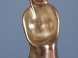 statue d'une femme les bras croisés posée sur une table blanche