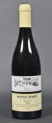 bottle of red wine on a gray surface with a gray background
