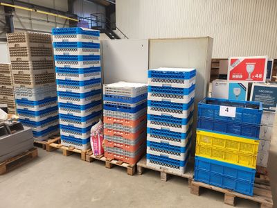 many crates stacked on pallets in a warehouse