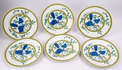 six blue and white plates with birds on them on a white surface