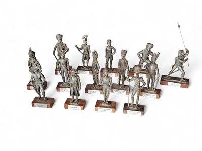 a lot of statues that are on display on a table