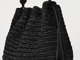 a black crocheted bag with a black handle