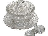 a glass box with a lid and a spoon on it