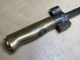 a small metal object on a table with a knife in it
