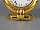 a gold clock with roman numerals on it