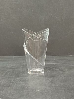 a glass vase with a piece of paper in it on a table