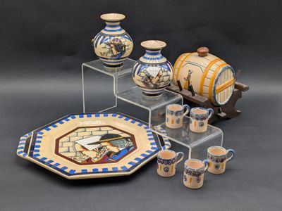many different types of pottery on display on the table