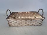 a silver basket that is sitting on a table