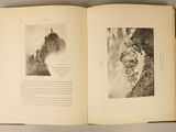 an open book with a picture of a mountain on it