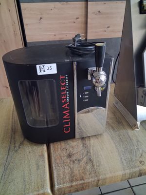 a coffee maker sitting on a wooden table in a kitchen
