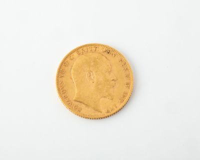 a close up of a gold coin on a white surface
