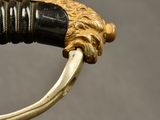 a close up of a sword with a lion head on it