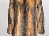 a close up of a fur coat on a mannequin stand