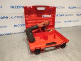 a red tool box with a cordless nail gun in it