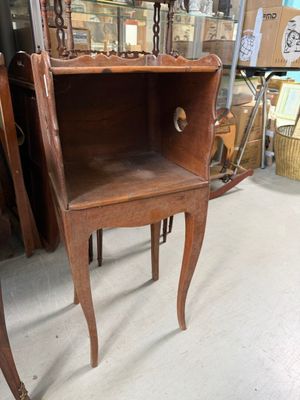 a small wooden table with a drawer on it