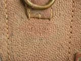 a close up of a brown leather bag with a ring on it