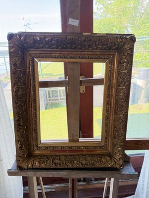 a picture of a mirror on a stand in front of a window