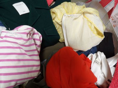 a lot of clothes in a basket on the floor