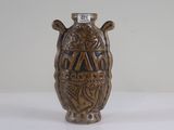 a brown vase sitting on a table with a number on it