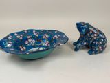 two small blue and green bowls with a frog figurine in the middle