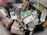 a pile of electronic devices in a bag on the floor