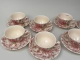 six cups and saucers are arranged in a circle on a table