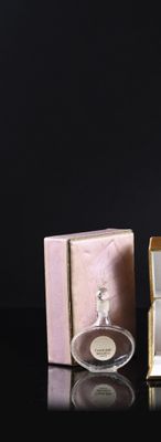 a bottle of perfume sitting next to a box of perfume