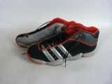 a pair of black and red shoes on a white surface