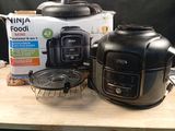 a box of food sitting on a table next to an air fryer