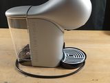 a coffee maker that is sitting on a wooden table