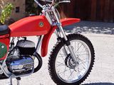 a red dirt bike parked on the side of the road